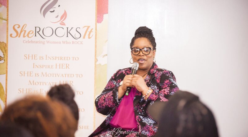 Founder of She Rocks it Speaking on Microphone